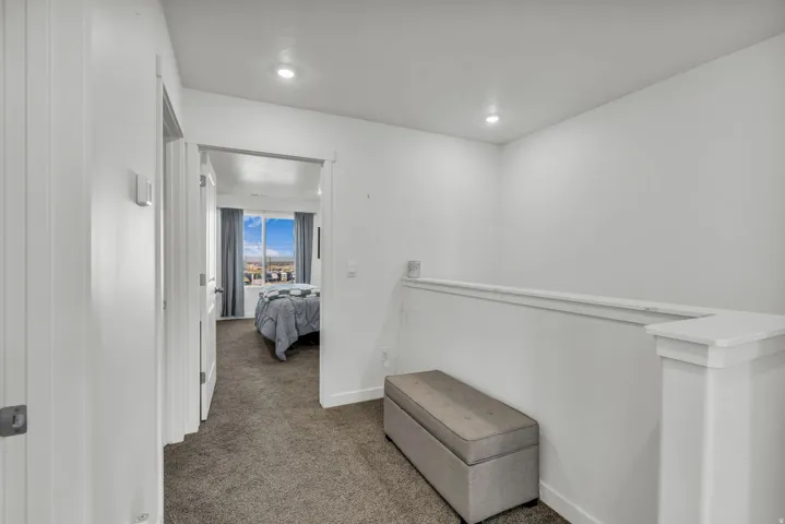 Corridor with carpet flooring and recessed lighting