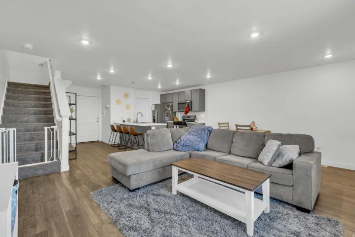 Living room with dark wood-type flooring and recessed lighting