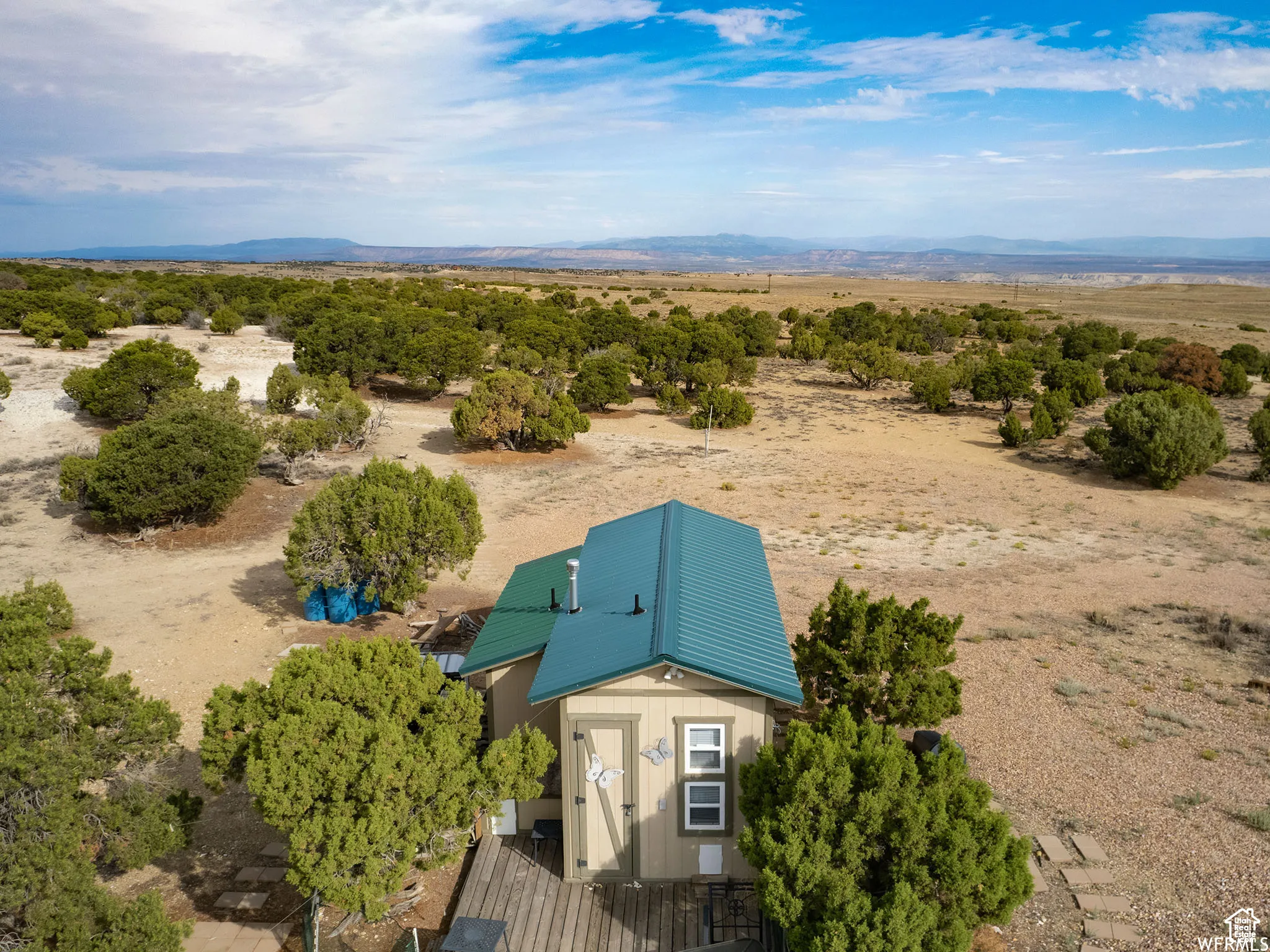 View of rural area with a mountain backdrop and a desert landscape