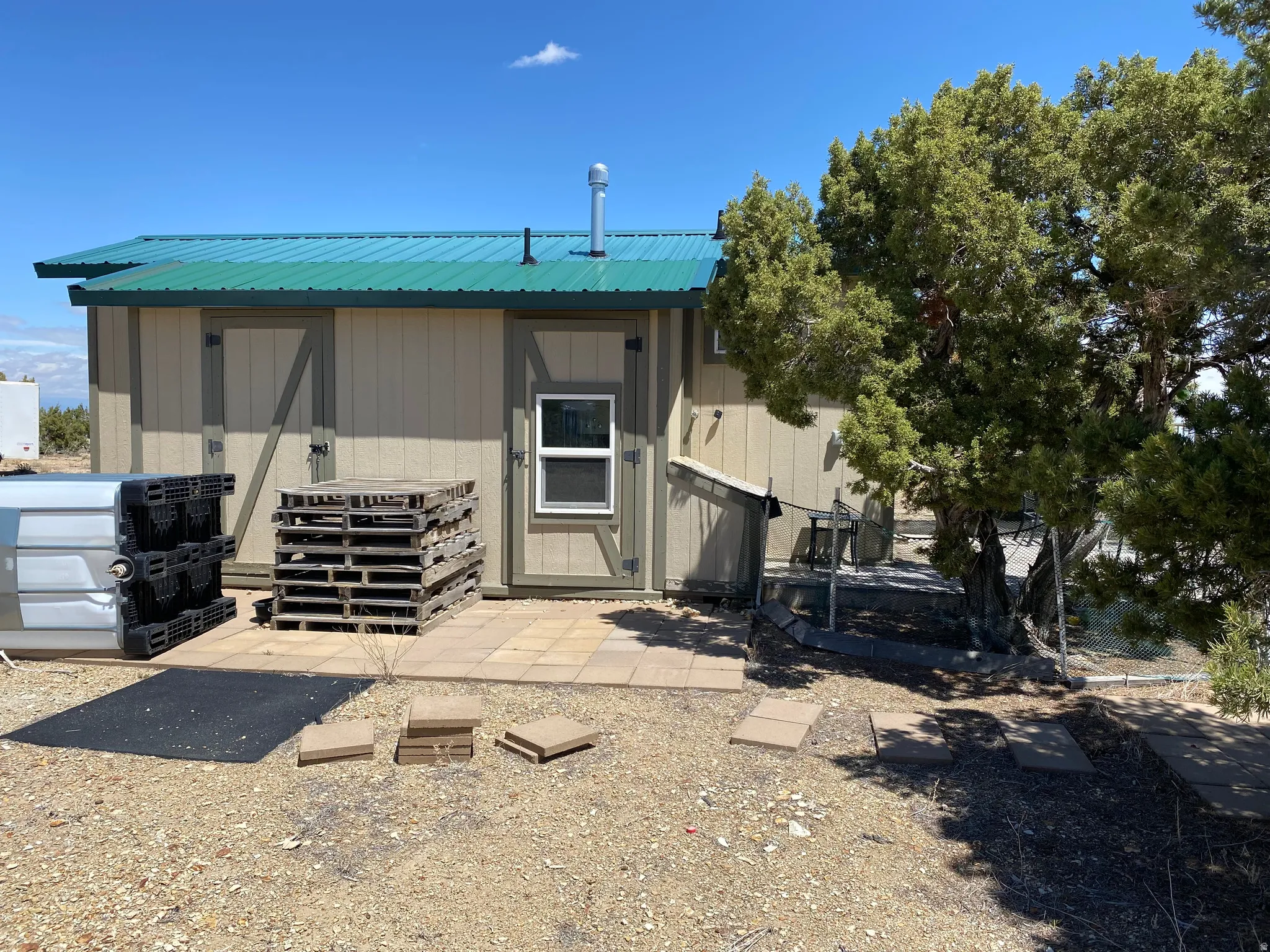 Back of house featuring a metal roof