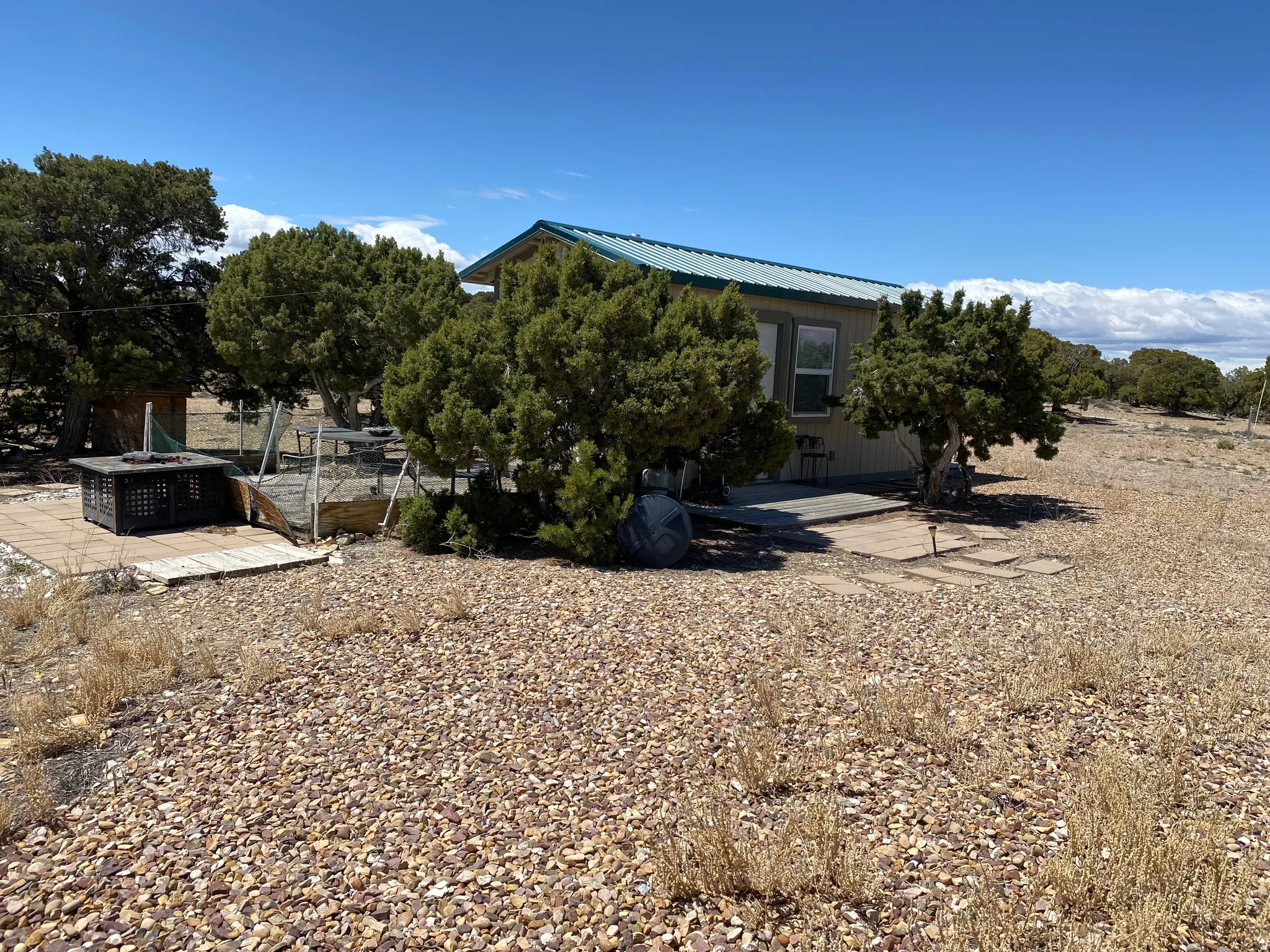 View of home's exterior featuring a patio area and a metal roof
