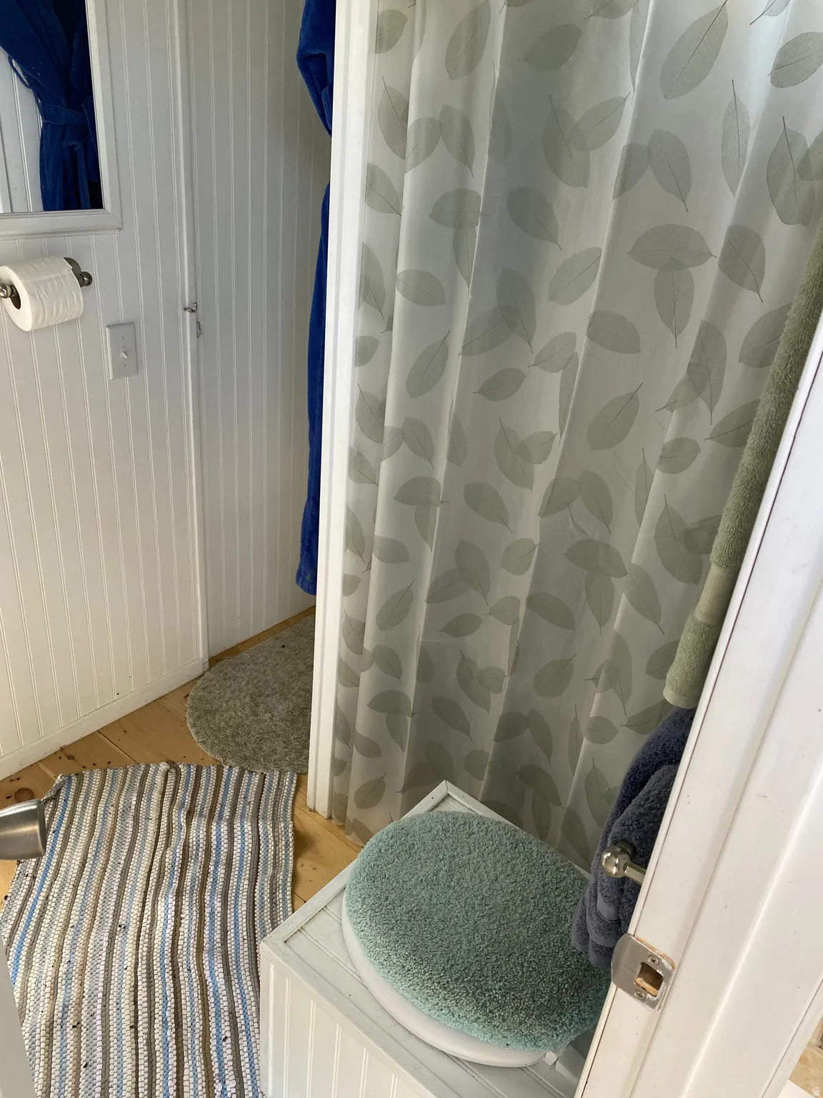 Full bathroom with a shower stall and light wood-type flooring