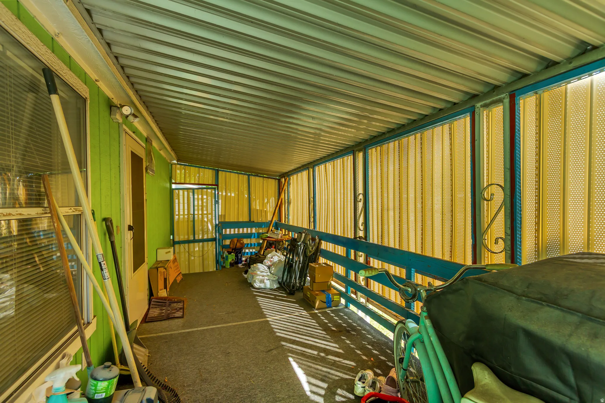 Covered patio featuring a corrugated metal roof and enclosed screening
