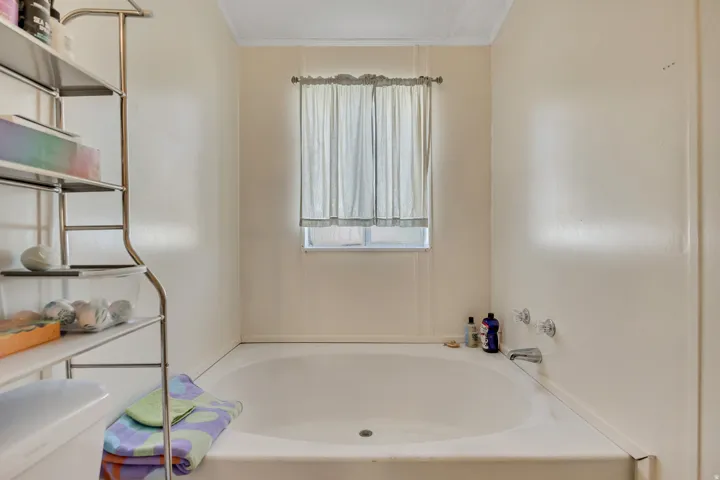Full bathroom with a bath and crown molding