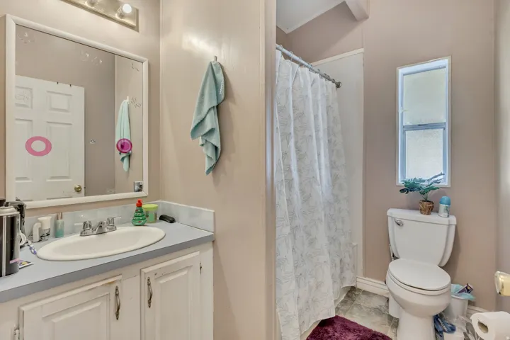 Full bath featuring a shower with shower curtain and vanity