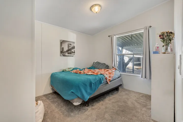 Carpeted bedroom with ornamental molding