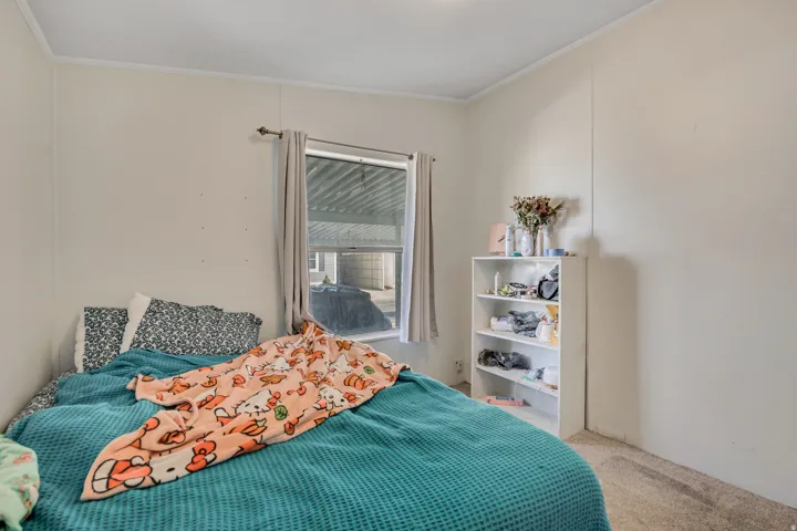 Bedroom with light colored carpet and ornamental molding