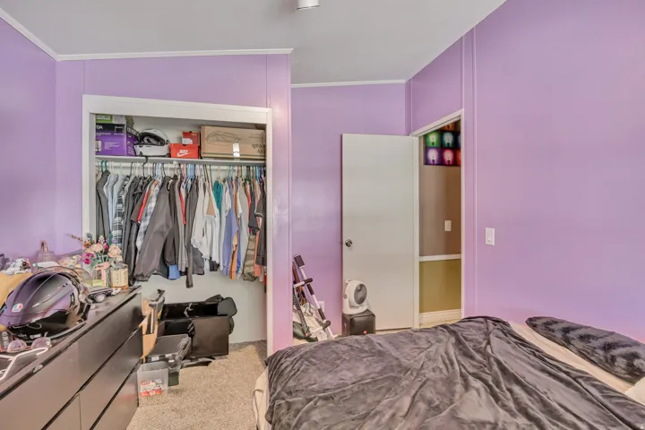 Bedroom with carpet, a closet, and ornamental molding