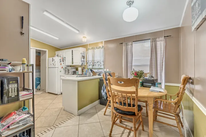Dining area featuring light tile patterned floors, lofted ceiling, and plenty of natural light