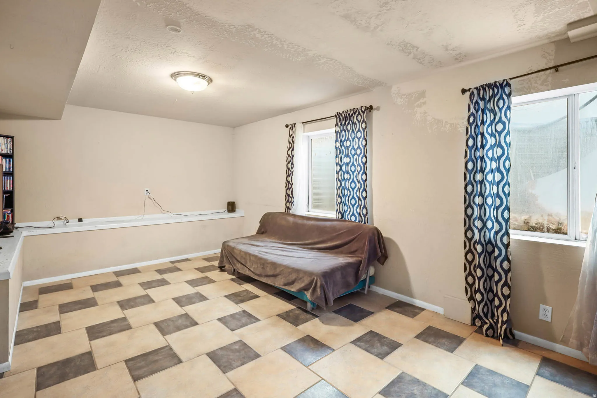 Bedroom with baseboards and a textured ceiling