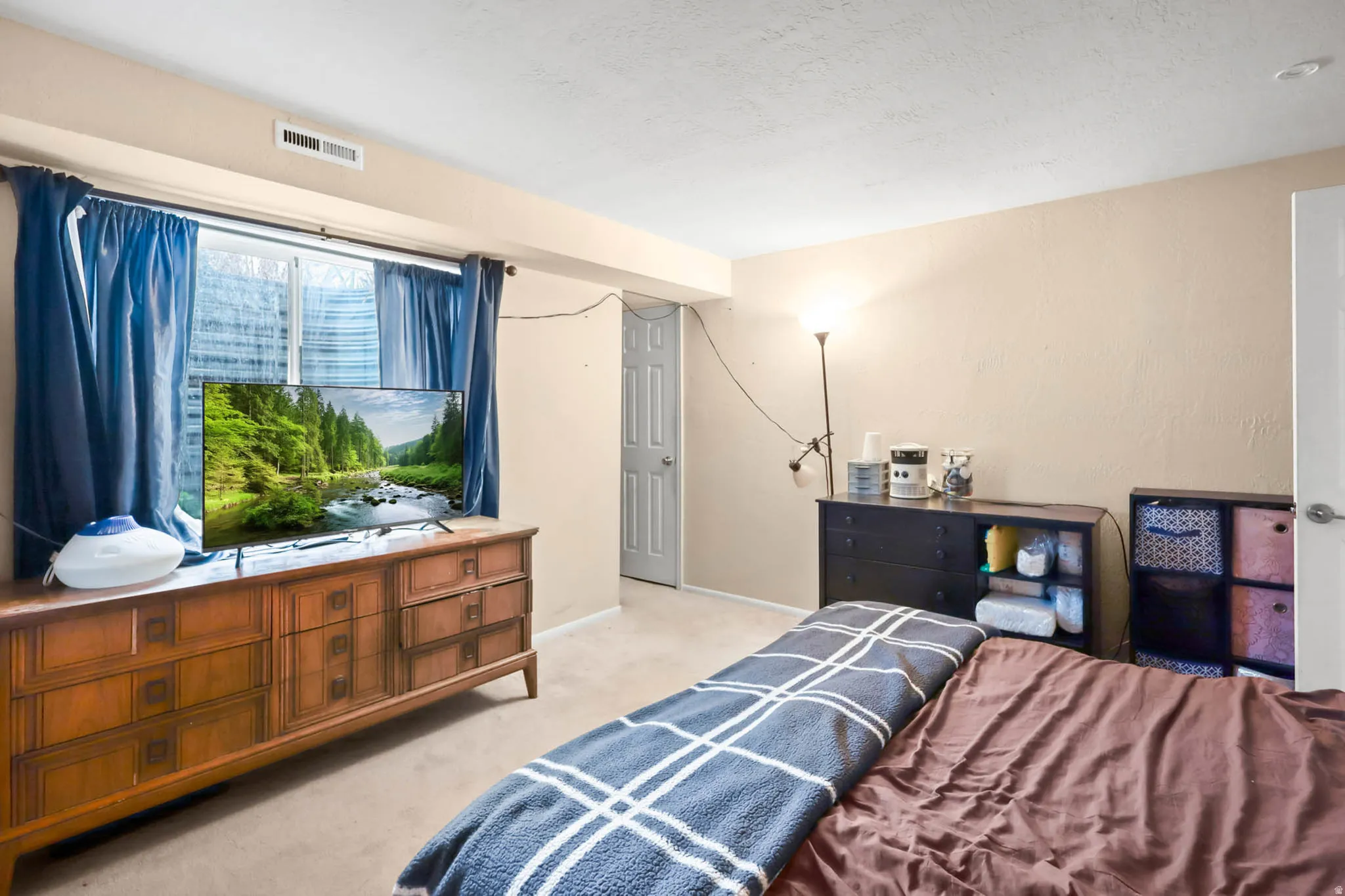 Bedroom featuring light colored carpet and baseboards