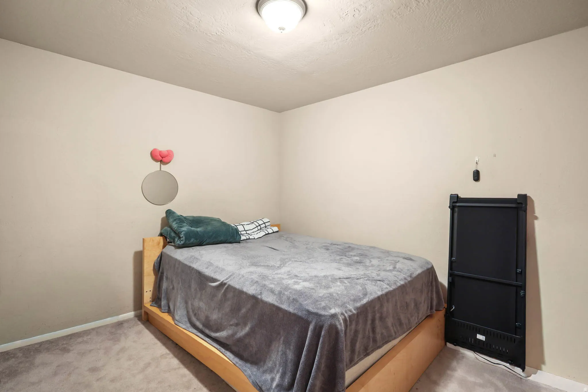 Bedroom featuring carpet flooring and a textured ceiling