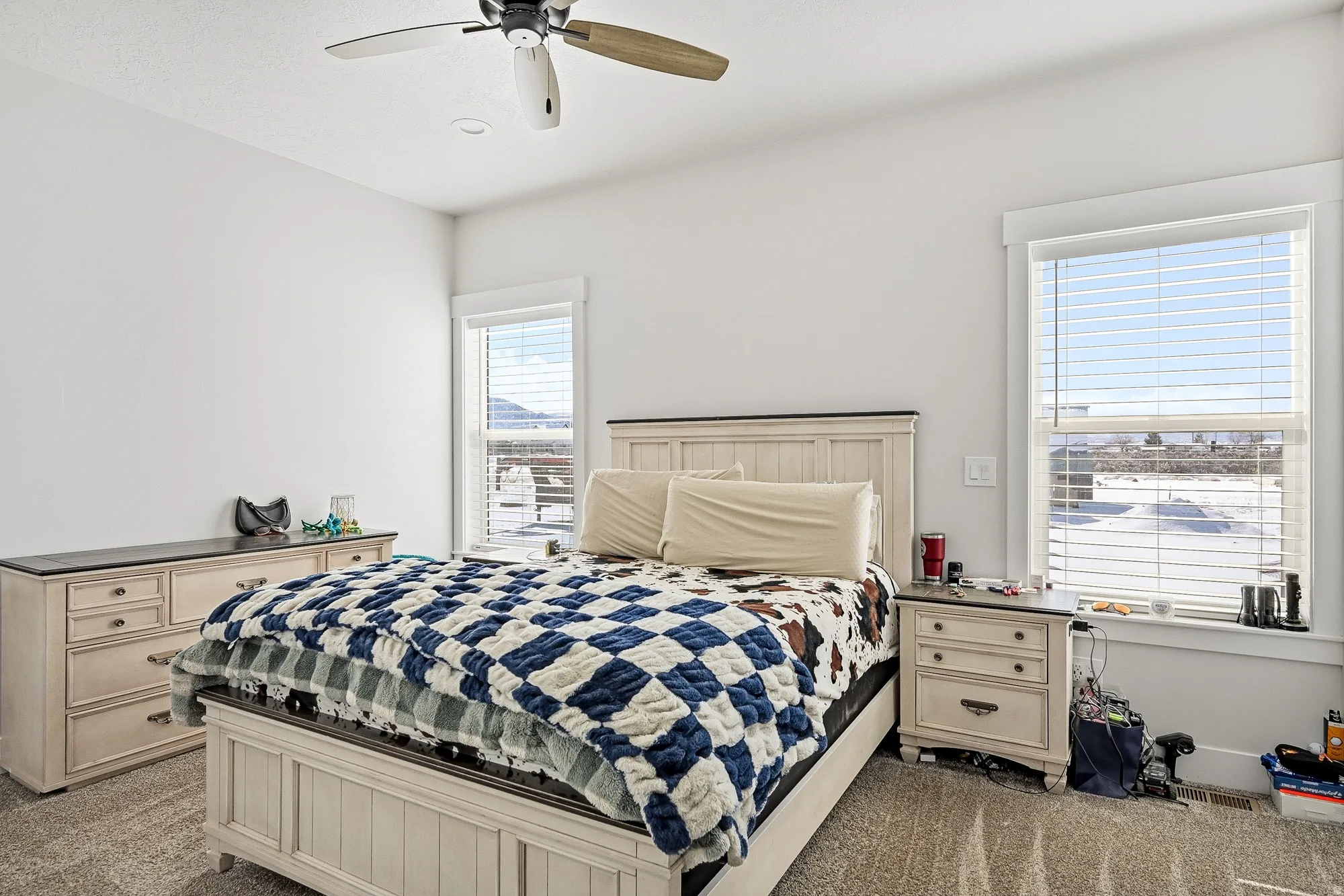 Bedroom featuring light carpet and a ceiling fan