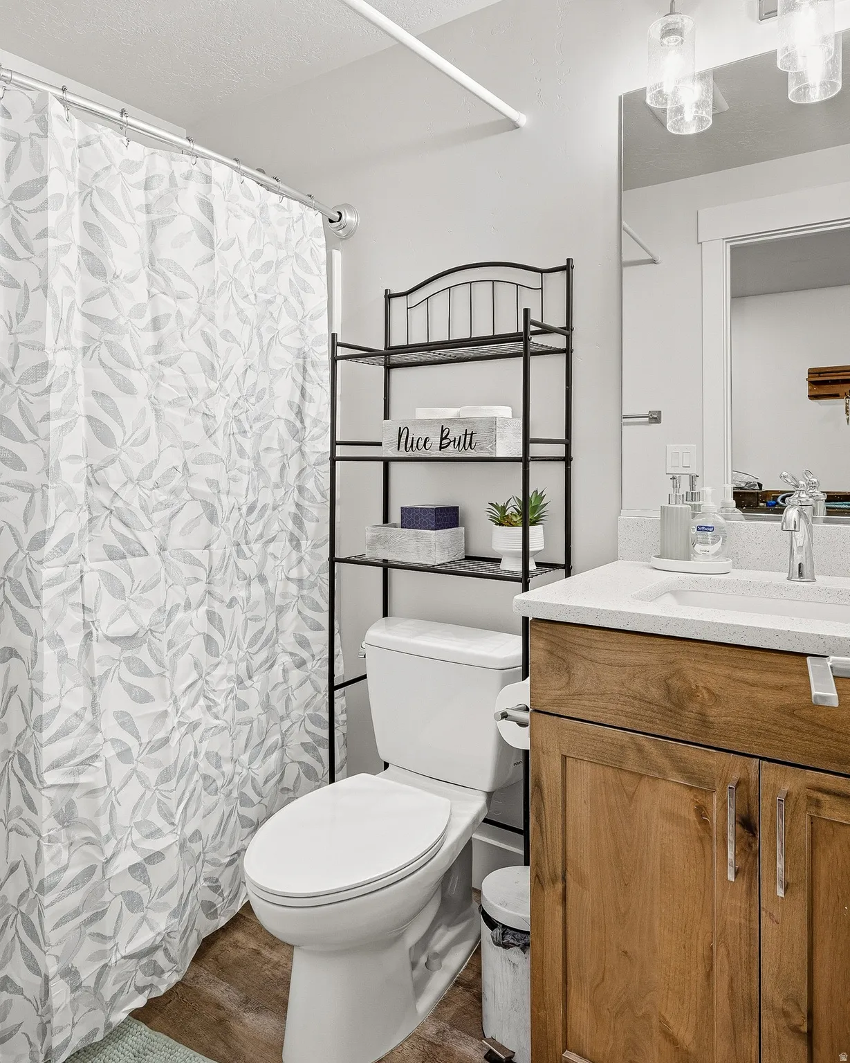 Full bath with a shower with curtain, vanity, and dark wood-style floors