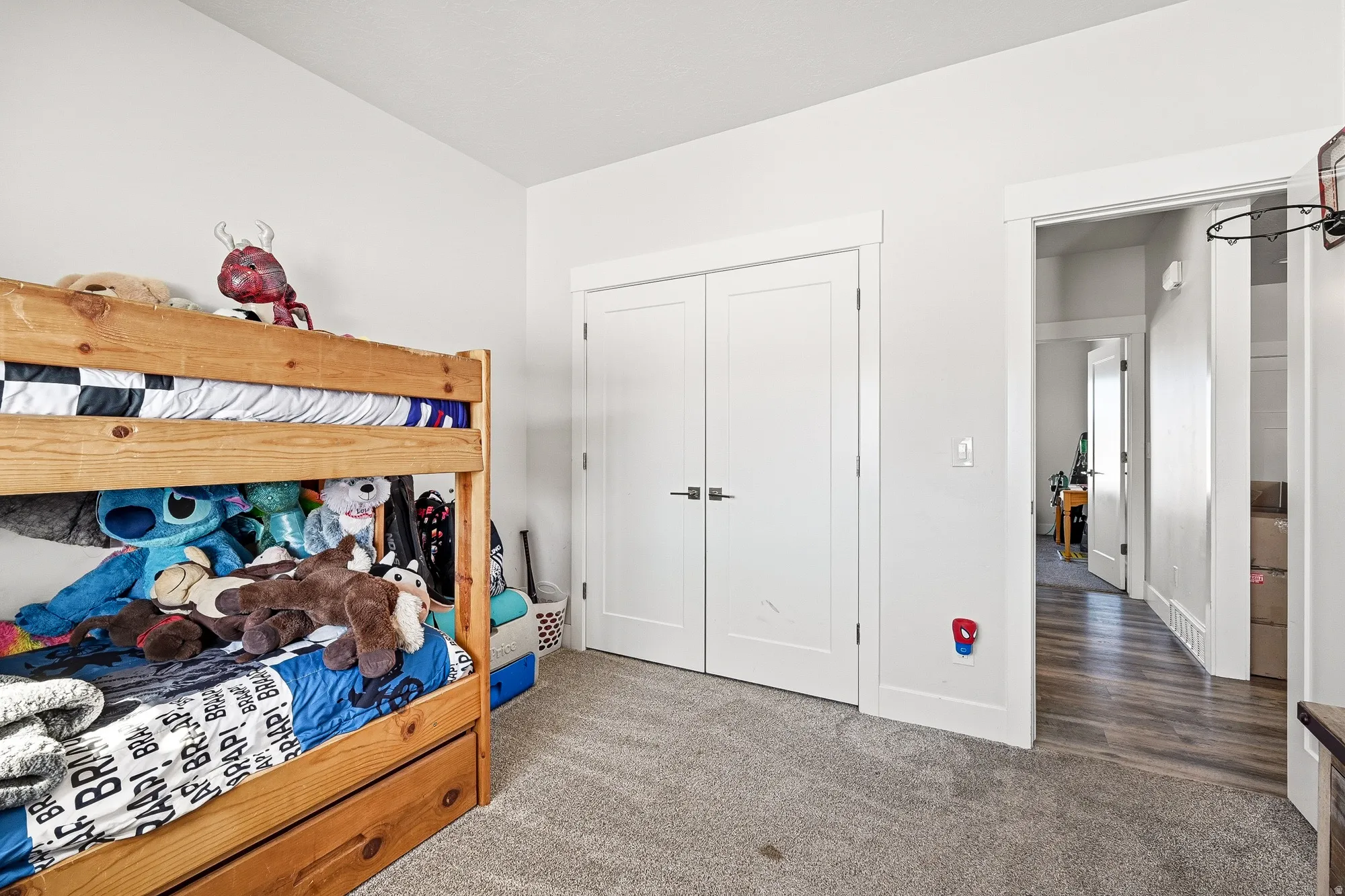 Carpeted bedroom featuring a closet and baseboards