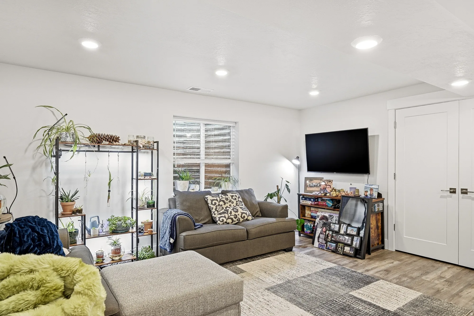 Living room with wood finished floors and recessed lighting