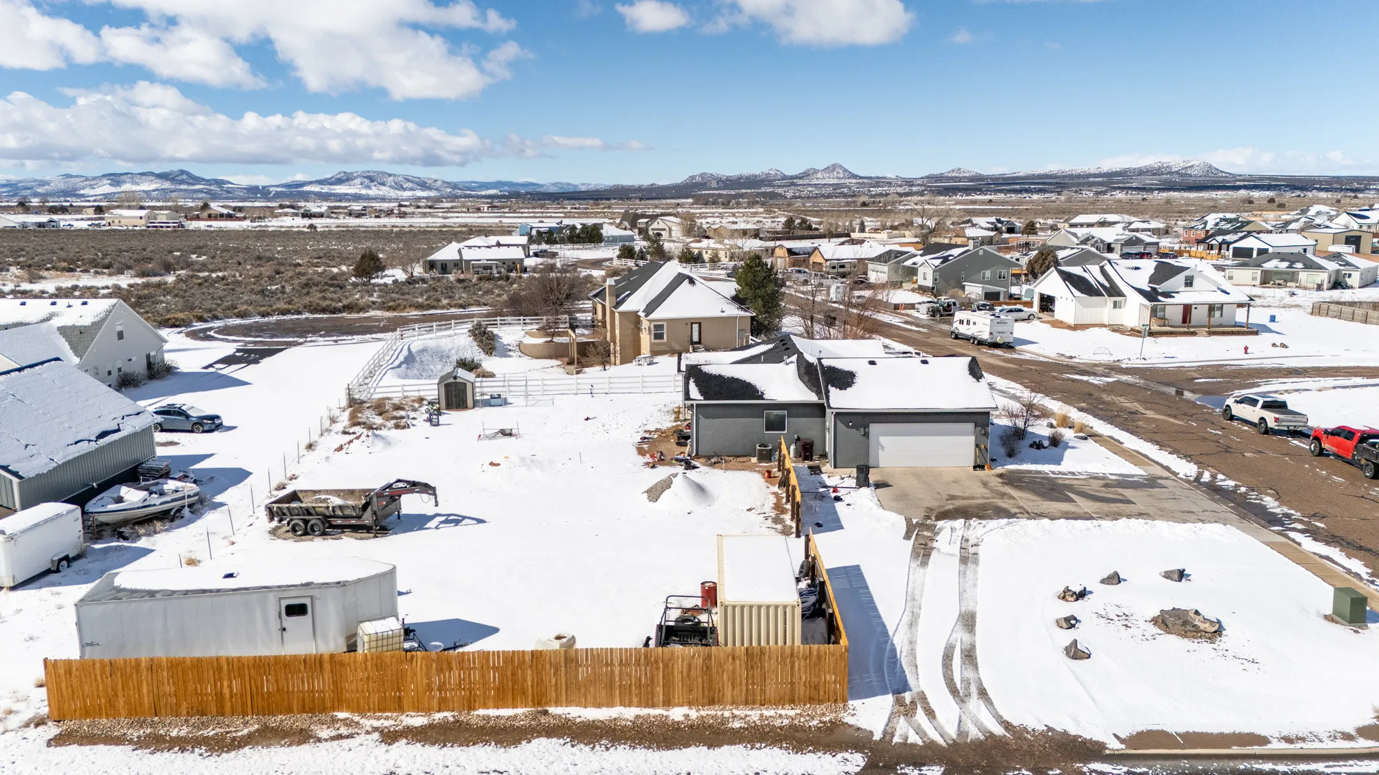 Snowy aerial view featuring a residential view and a mountain view