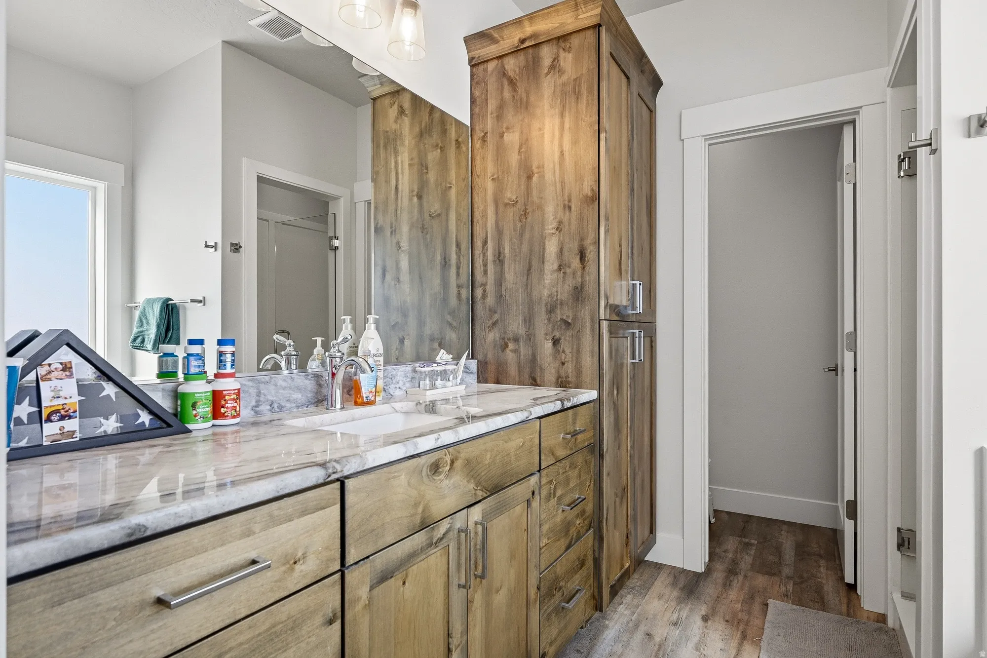 Full bathroom with vanity and dark wood-style flooring
