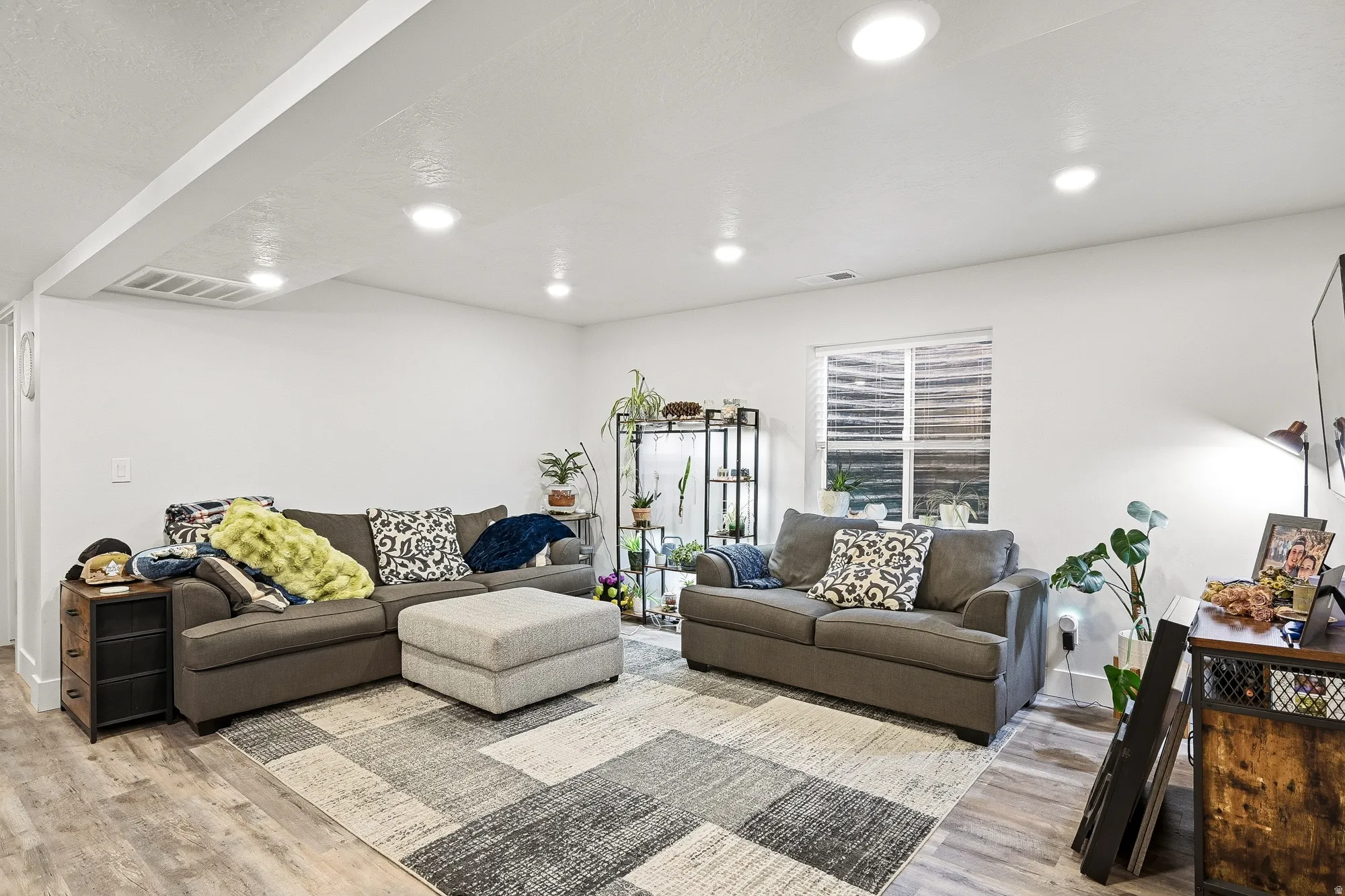 Living area featuring wood finished floors and recessed lighting