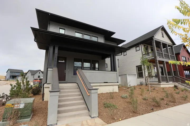 View of front of house with covered porch and board and batten siding