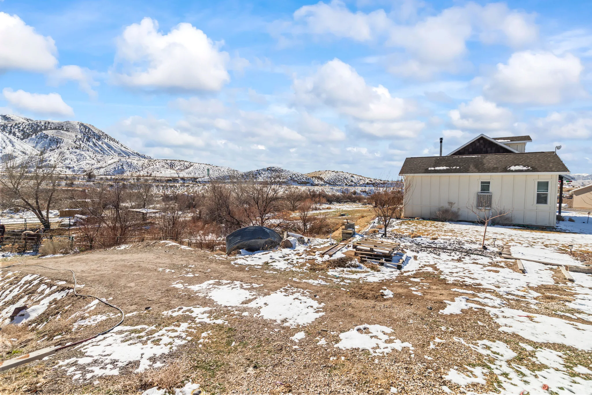 Yard covered in snow with a mountain view