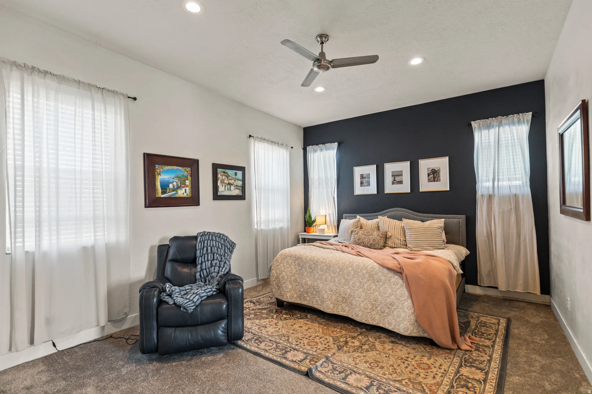 Carpeted bedroom featuring a ceiling fan and recessed lighting