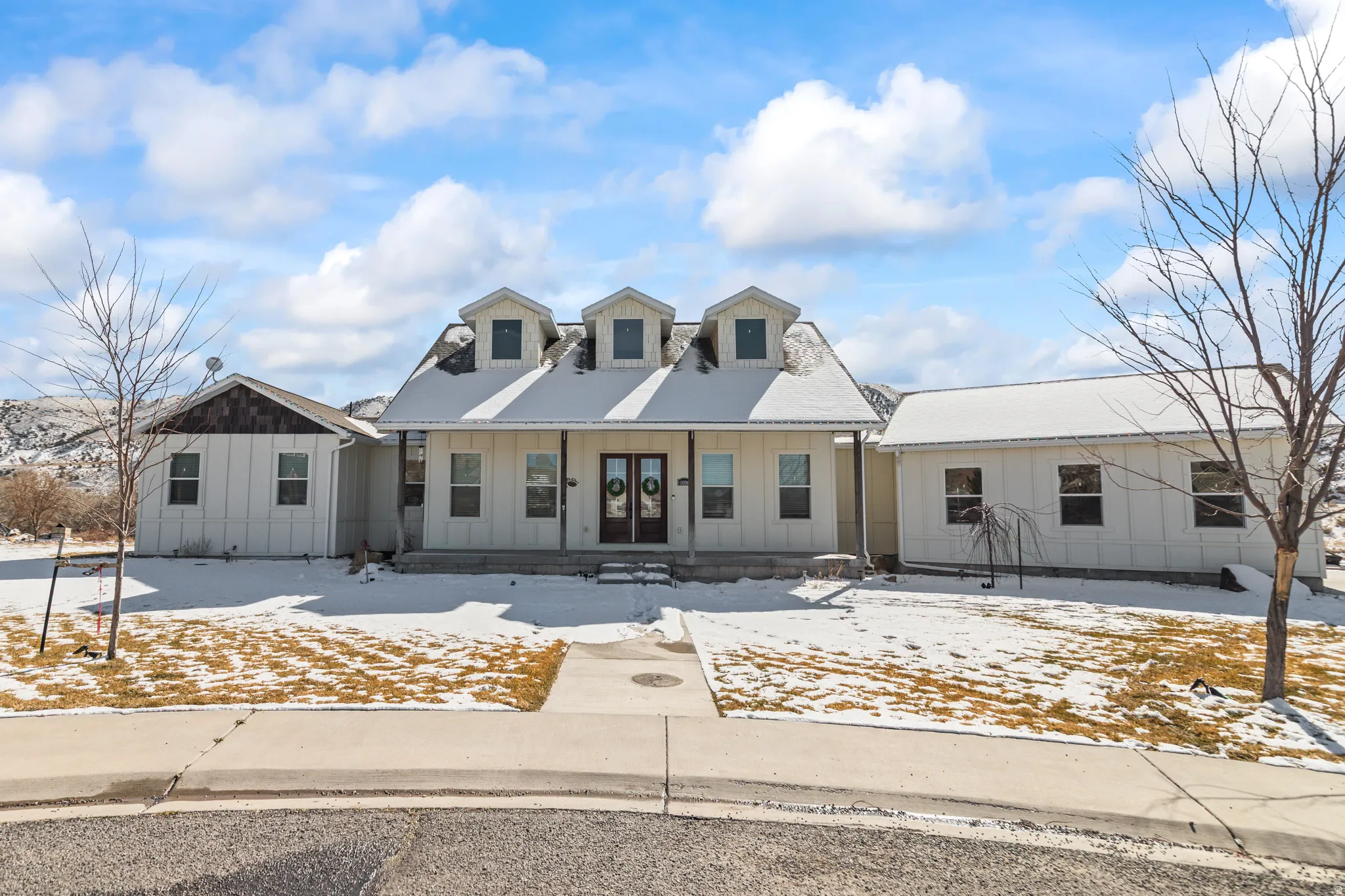 Modern farmhouse featuring board and batten siding and french doors