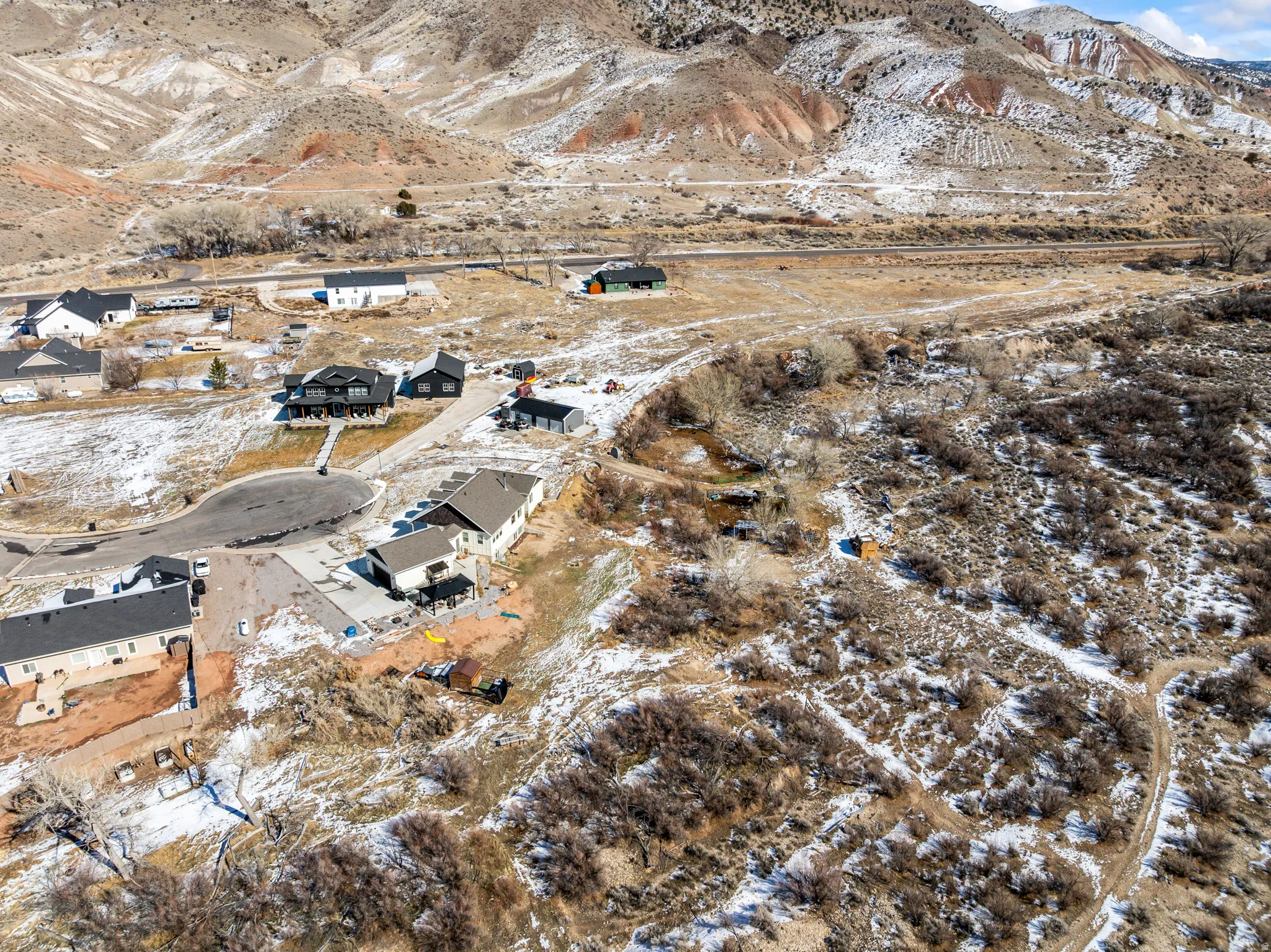 Snowy aerial view with a mountain view and a residential view