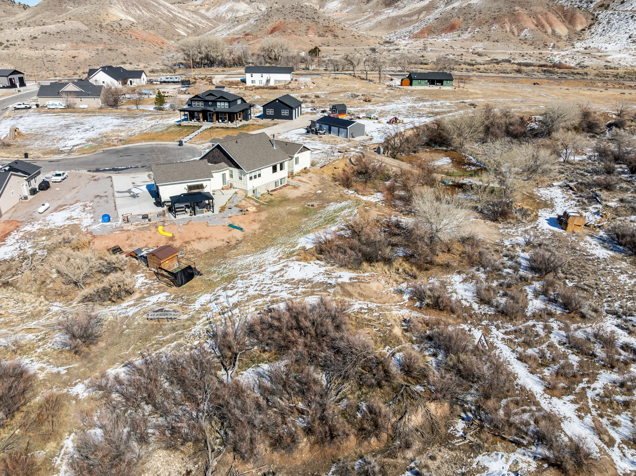 Snowy aerial view with a mountain view and a residential view