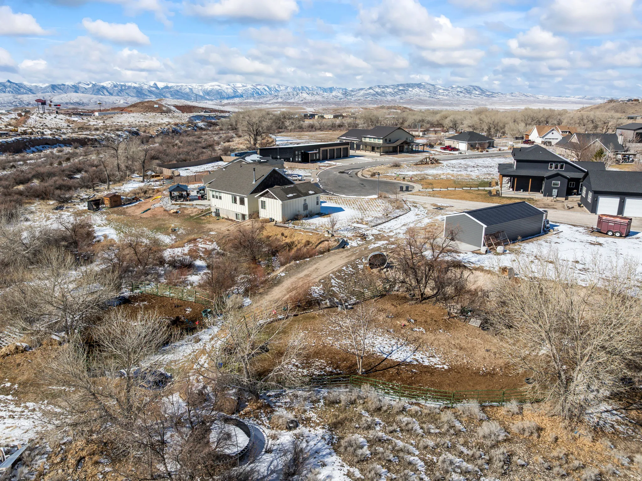 Snowy aerial view featuring a residential view and a mountain view