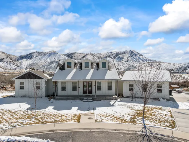 View of front of house with covered porch, a mountain view, and board and batten siding