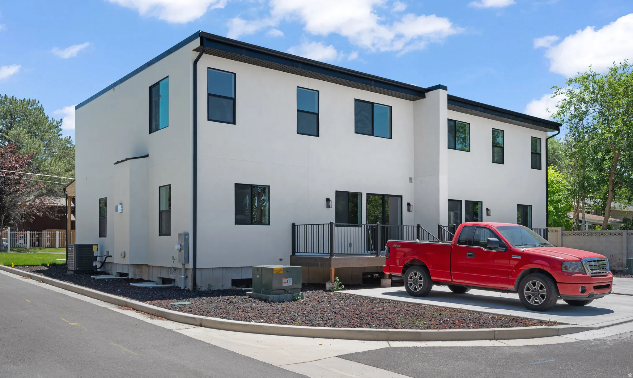 Contemporary multi-level exterior with white stucco finish and black trim
