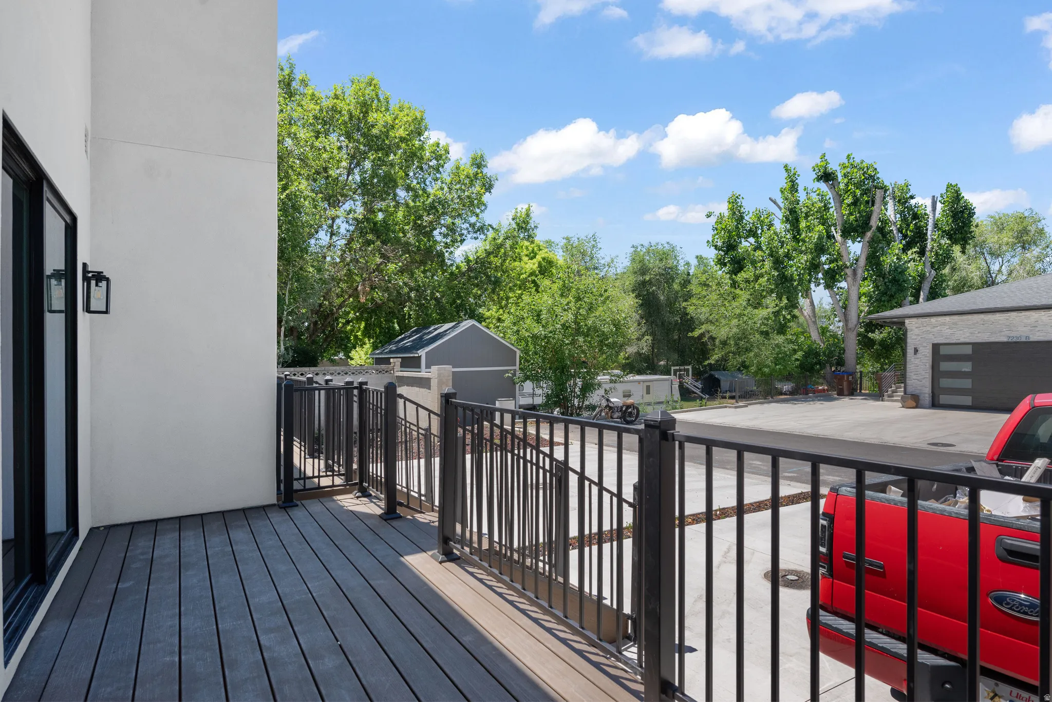 Spacious outdoor deck with composite decking and black metal railing