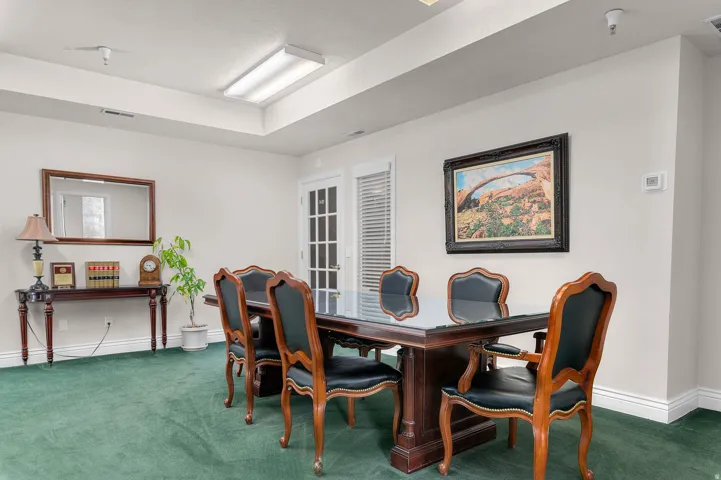 Carpeted dining space with baseboards