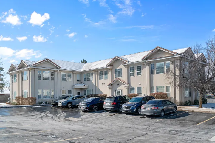 View of property featuring uncovered parking