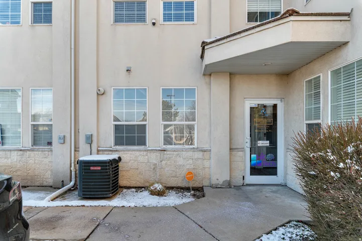 Entrance to property featuring stone siding and stucco siding
