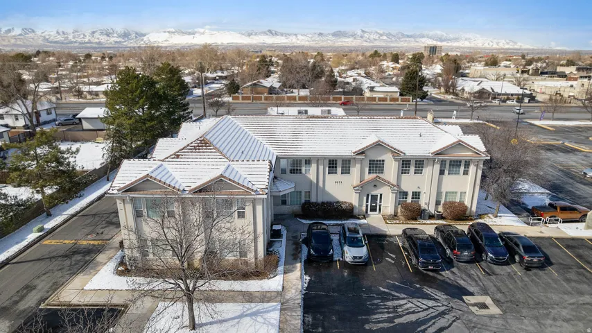 Snowy aerial view with a mountain view and a residential view