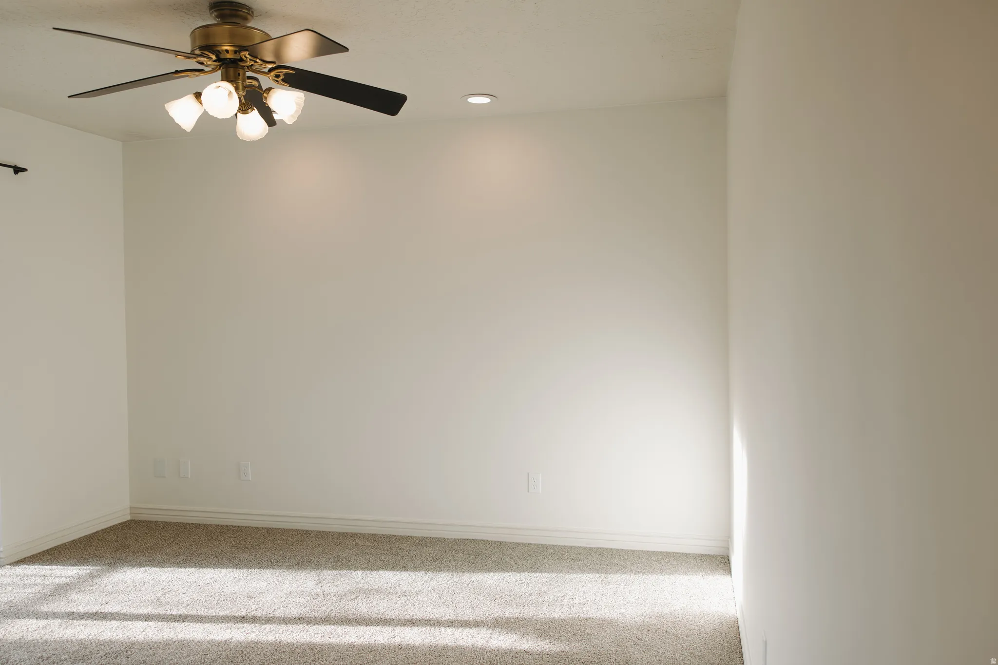 Spare room with recessed lighting, ceiling fan, and carpet