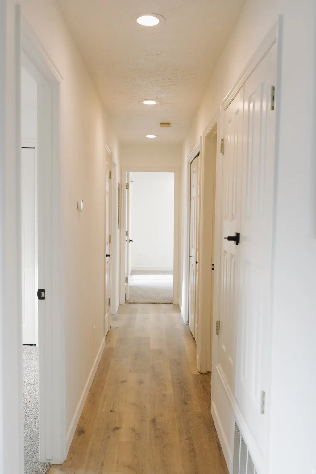 Hallway featuring recessed lighting and light wood-style flooring