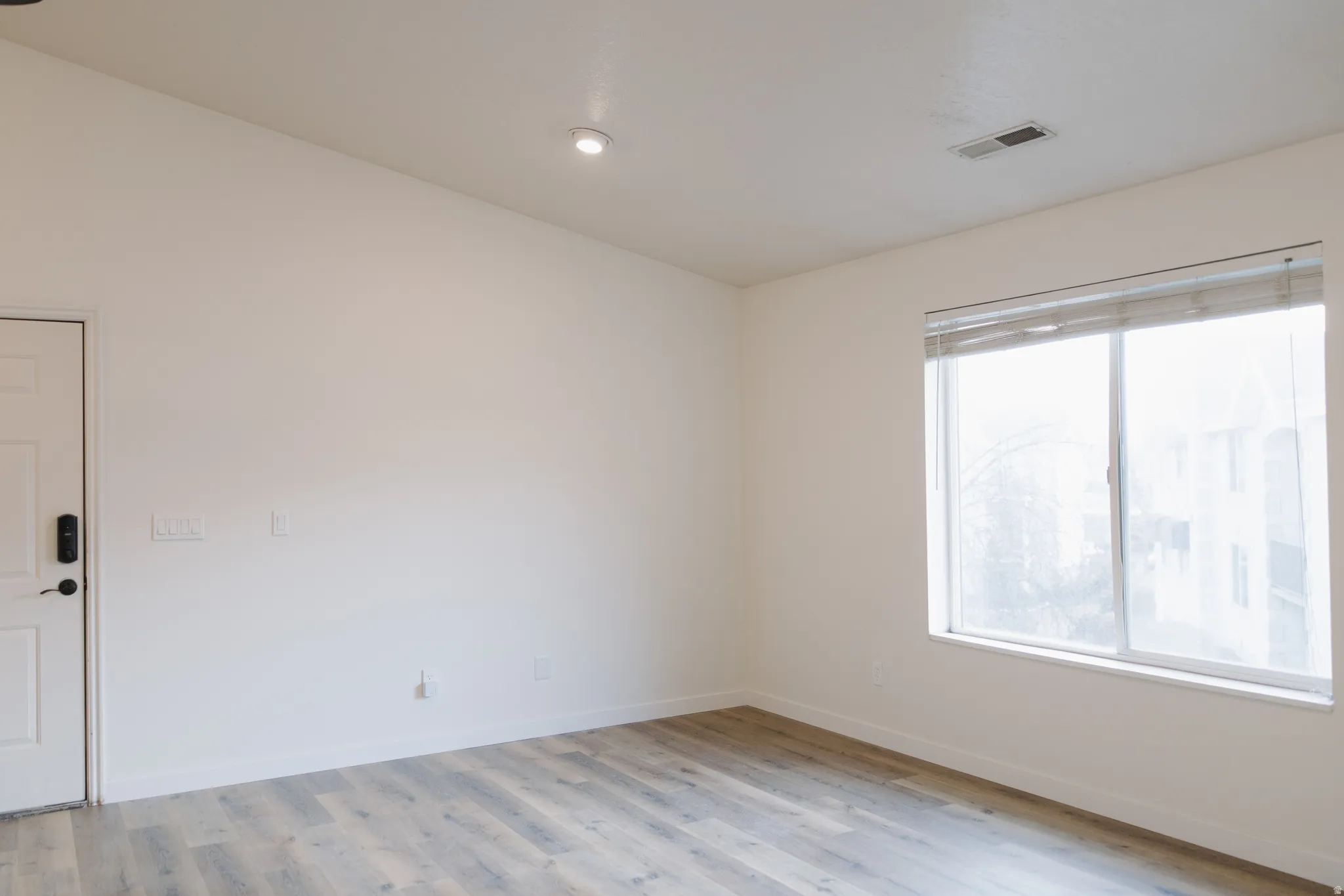 Spare room with light wood finished floors and baseboards
