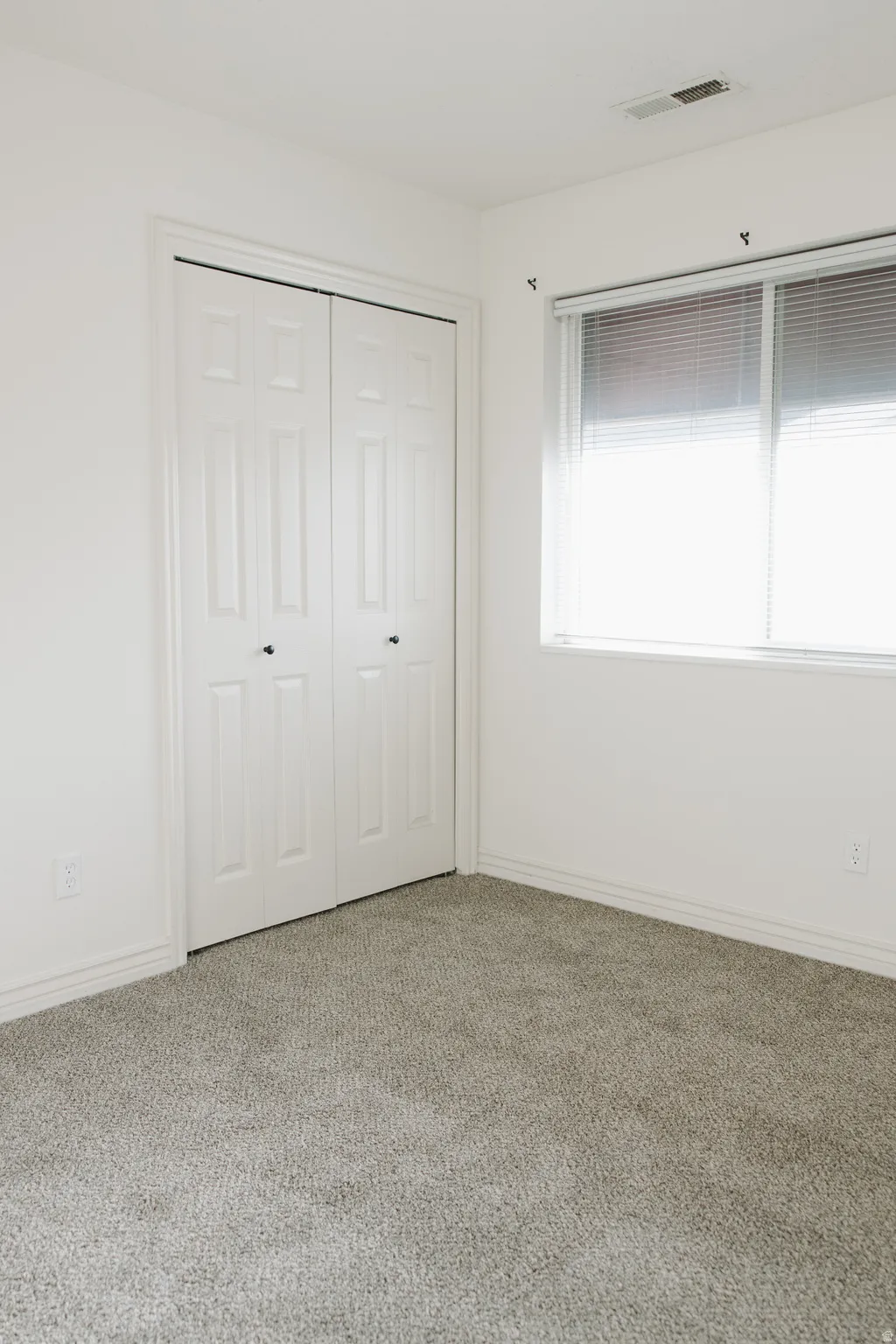Unfurnished bedroom with carpet floors and a closet