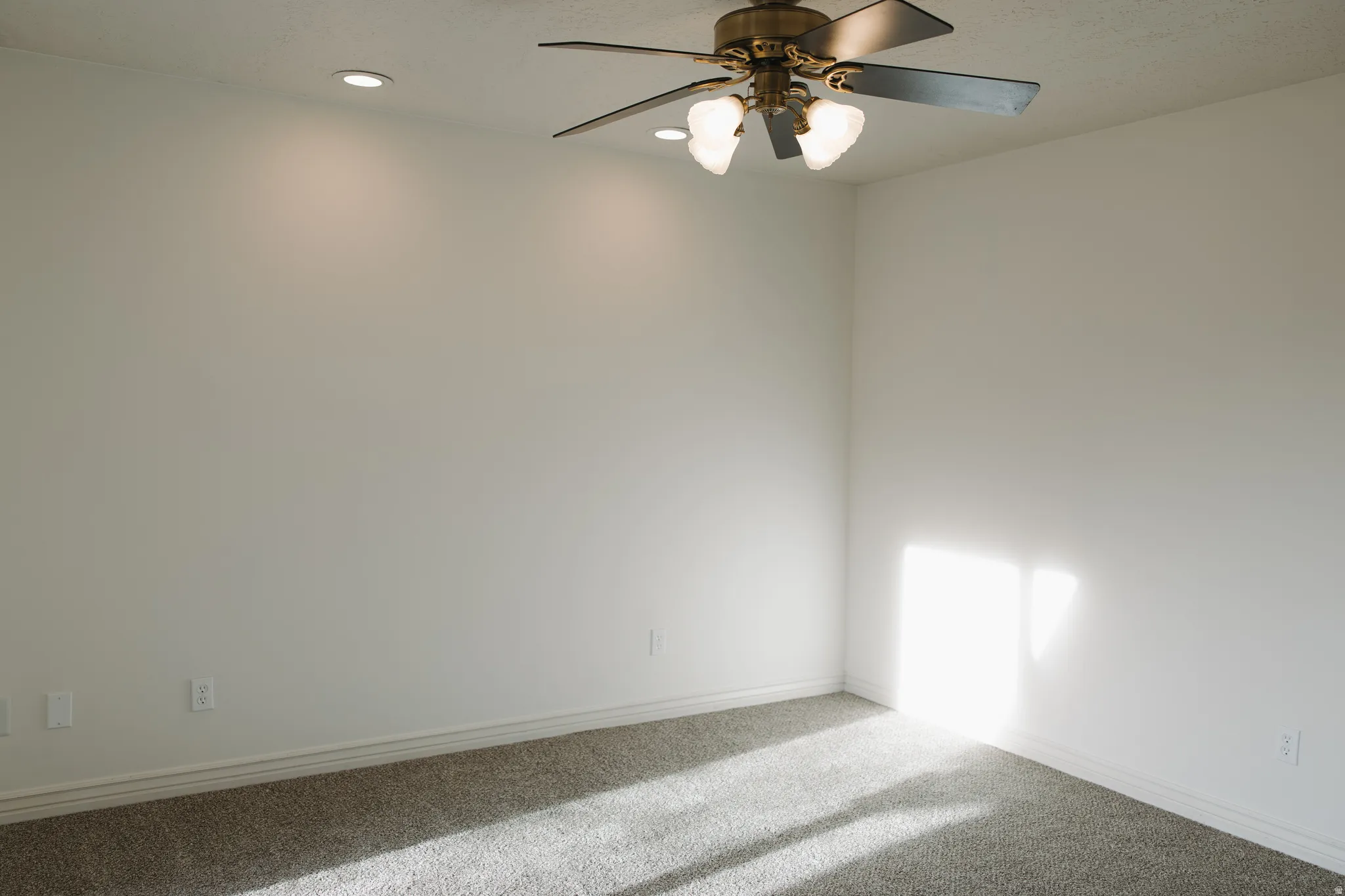 Empty room with a ceiling fan, carpet flooring, and recessed lighting