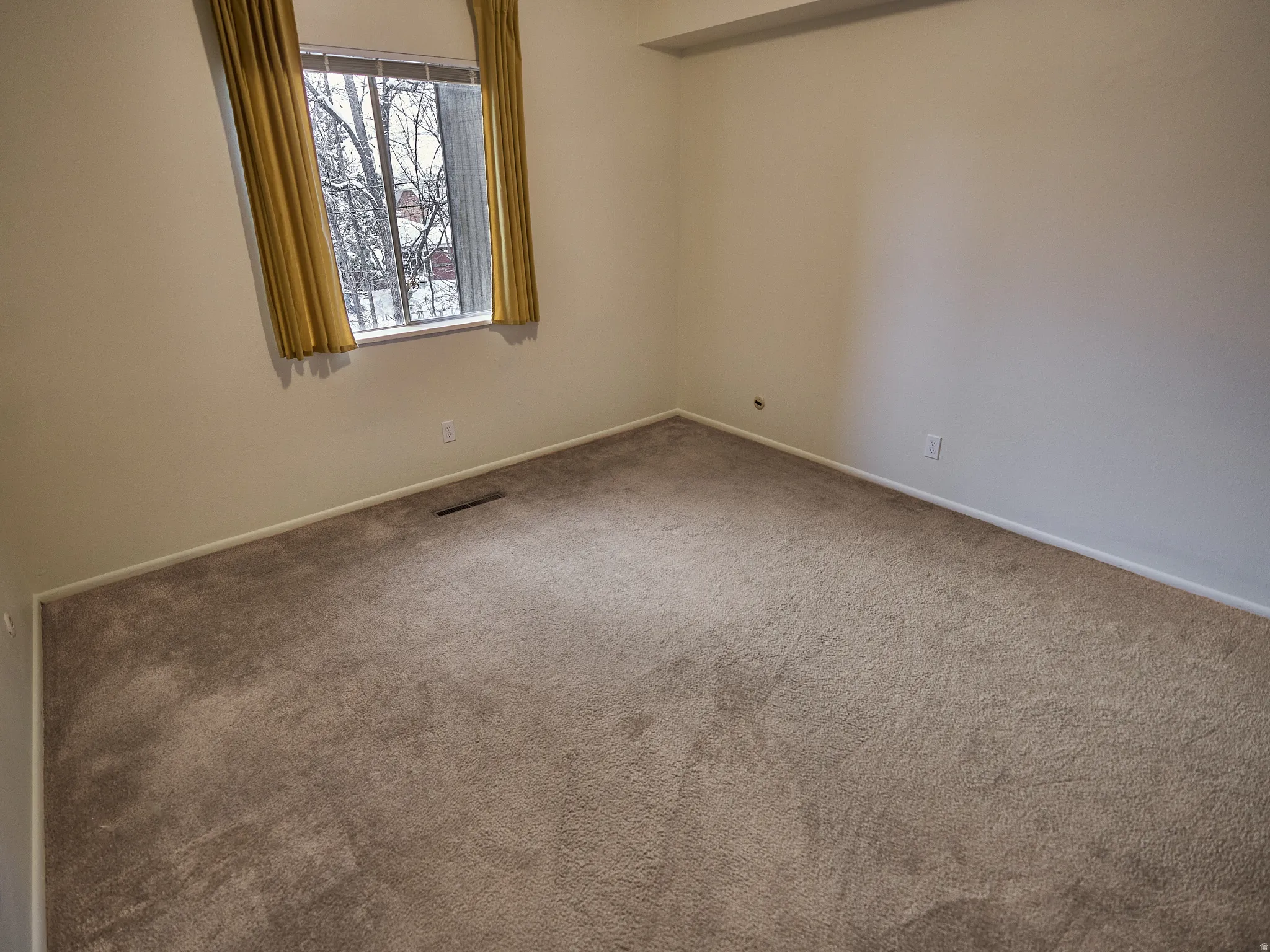 Unfurnished room featuring carpet flooring and baseboards