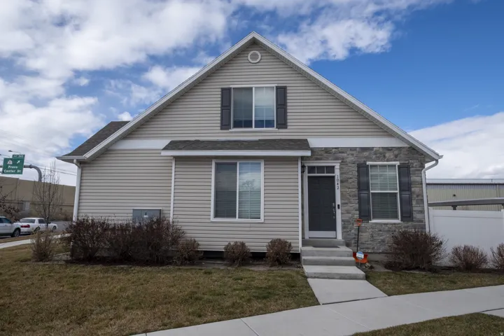 Bungalow-style home with stone siding and entry steps