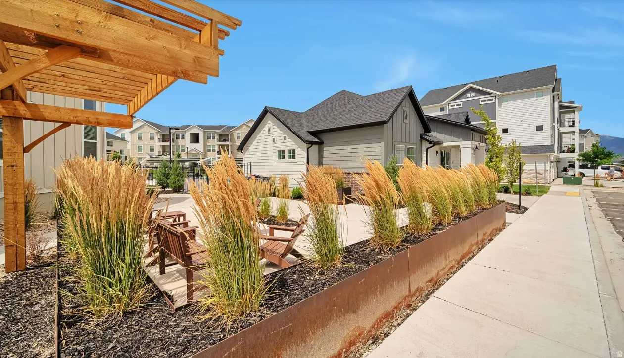 View of property exterior with a residential view, board and batten siding, and a pergola