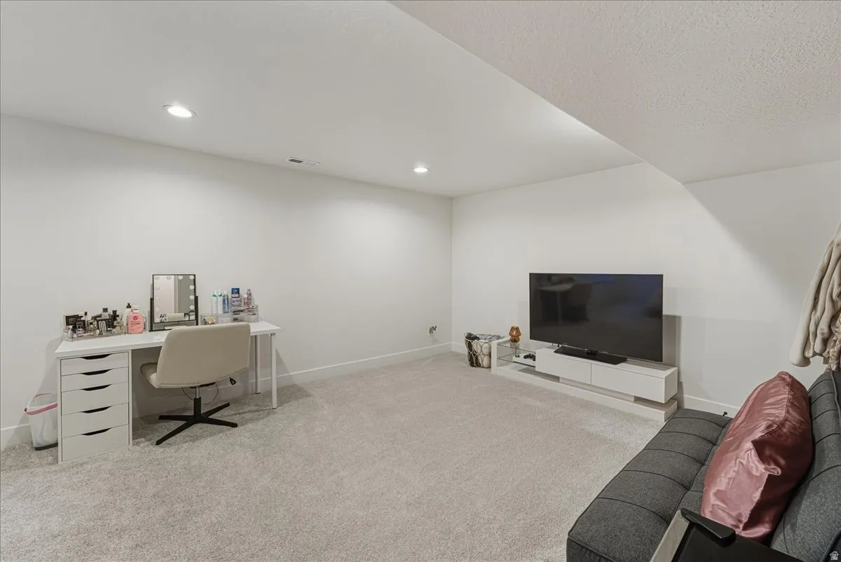 Office featuring light colored carpet and recessed lighting