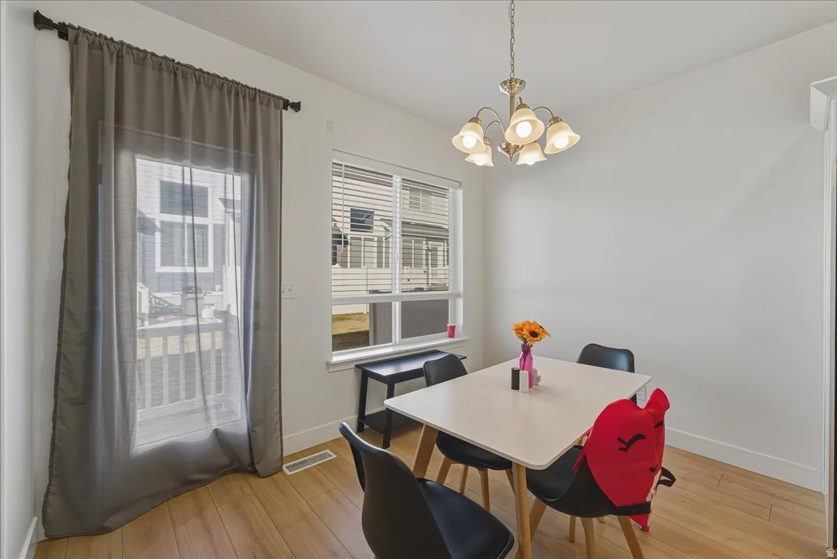 Dining area featuring a chandelier and light wood-style floors