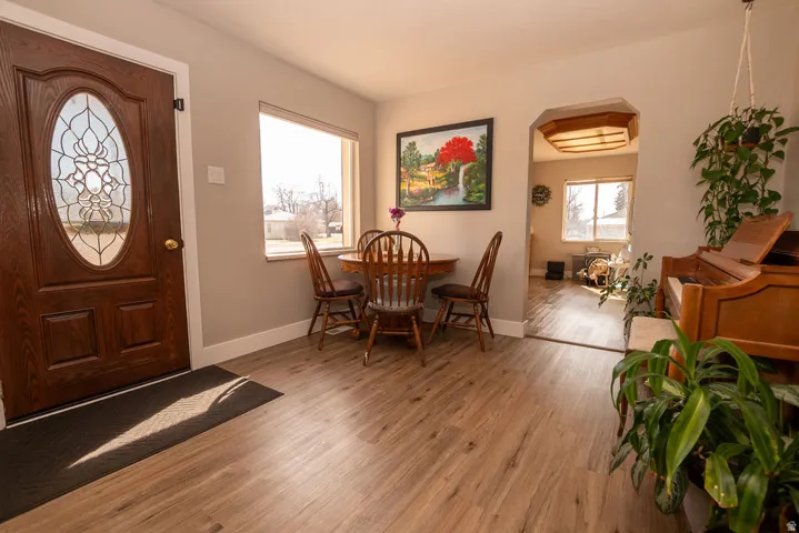 Entryway featuring light wood-style floors and arched walkways