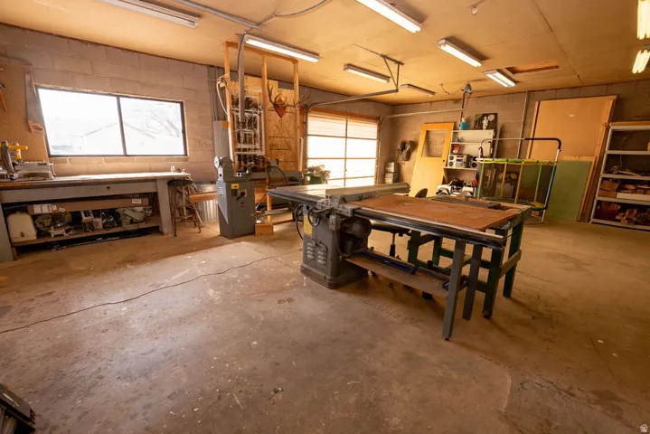 Garage with concrete block wall and a workshop area