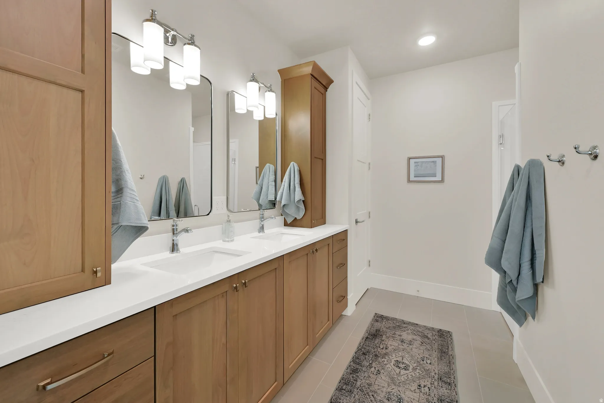 Full bathroom with double vanity, light tile patterned flooring, and recessed lighting